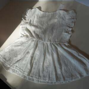 bellanblue White Embroidered Eyelet Peplum Top with Ruffle Sleeves